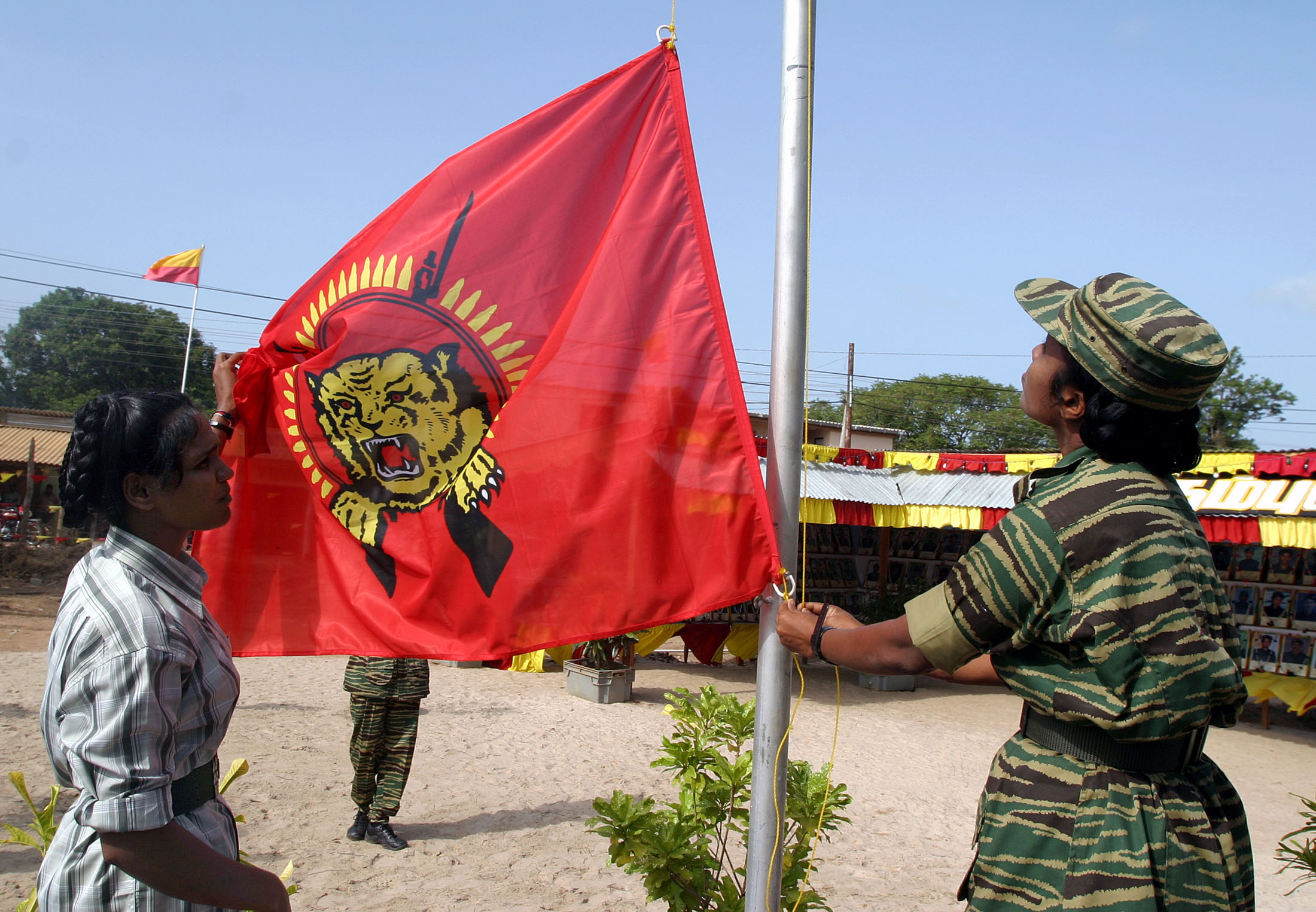 LTTE rebels raise their flag at a Black Tigers Day ceremony in the rebel-held northern Sri Lankan town of Kilinochchi, on July 5, 2004. Source: Anuruddha Lokuhapuarchchi/Reuters.