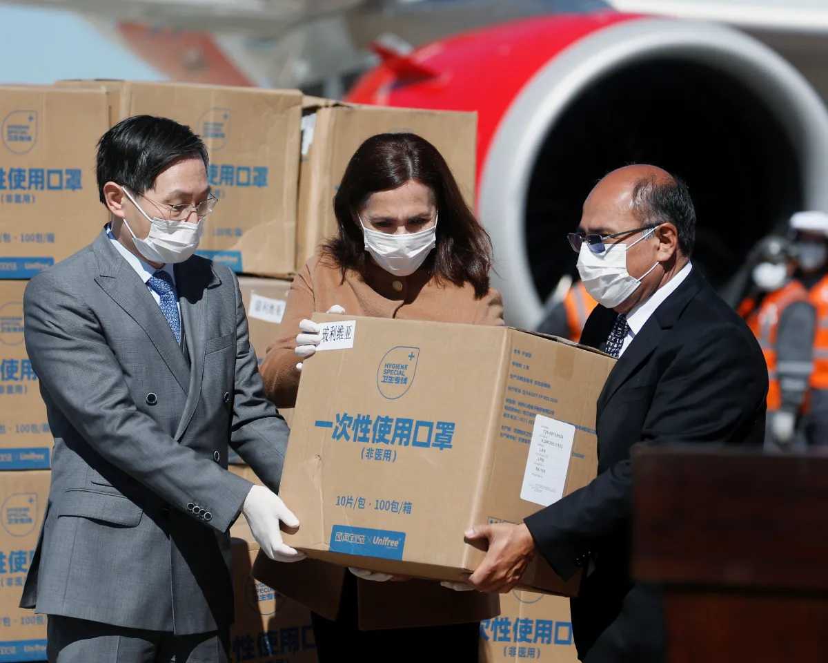 A photo showing China's Ambassador Huang Yazhong, Bolivia's Foreign Minister Karen Longaric, and Health Minister Anibal Cruz attending the donation ceremony of medical supplies at El Alto airport in La Paz, Bolivia, on April 2, 2020.