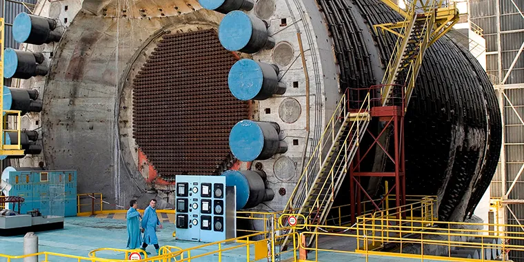 Two employees walk past a reactor at the Marcoule nuclear site in southeastern France.