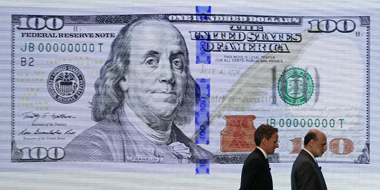 From left, U.S. Treasury Secretary Timothy Geithner and Federal Reserve Chairman Ben Bernanke leave a ceremony to debut the new design for the U.S. $100 bill at the Department of the Treasury in Washington on April 21, 2010.