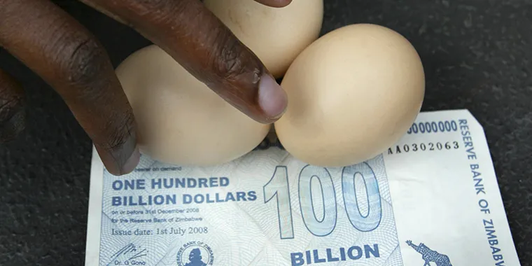A vendor arranges eggs on a 100 billion Zimbabwean dollar note in Harare, on July 22, 2008. At the time, an egg cost ZW$35 billion.