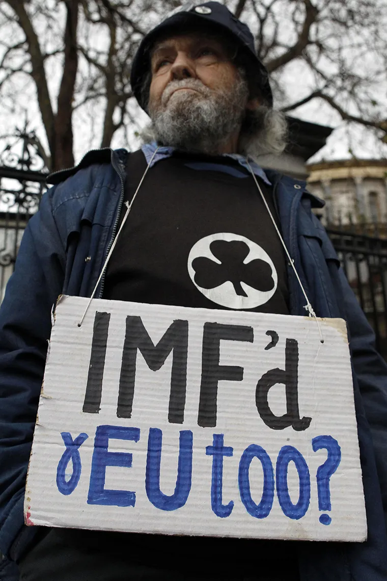 A demonstrator protests outside government buildings as the budget is announced in Dublin, Ireland, on December 7, 2010.