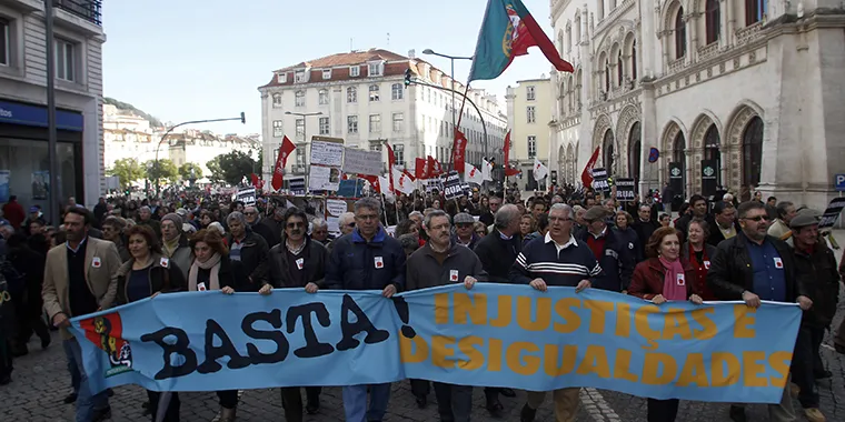 Demonstrators hold a banner that reads “Enough! Injustices and Inequalities” in Portuguese during a protest organized by General Confederation of the Portuguese Workers union in Lisbon on February 1, 2014.