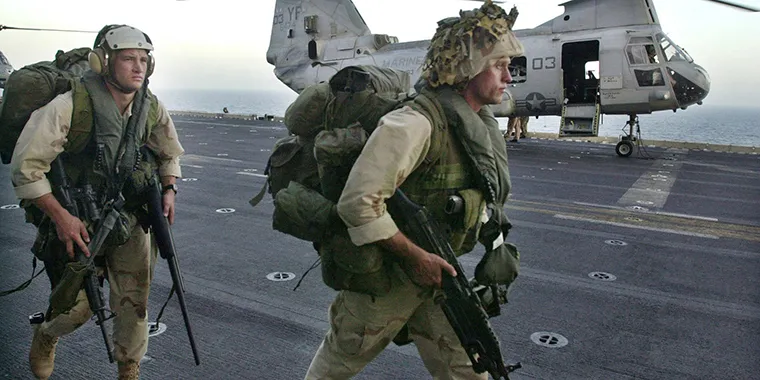 U.S. marines supporting Operation Enduring Freedom disembark from an amphibious assault ship, on October 29, 2001. 