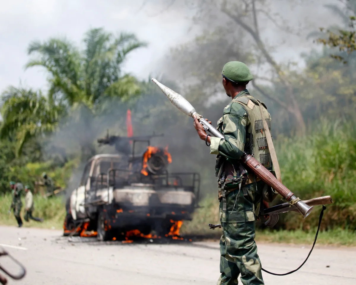 A photo showing a Democratic Republic of Congo soldier looking at his burning vehicle after an ambush by rebel group ADF-NALU near the village of Mazizi in the country’s North Kivu province on January 2, 2014.