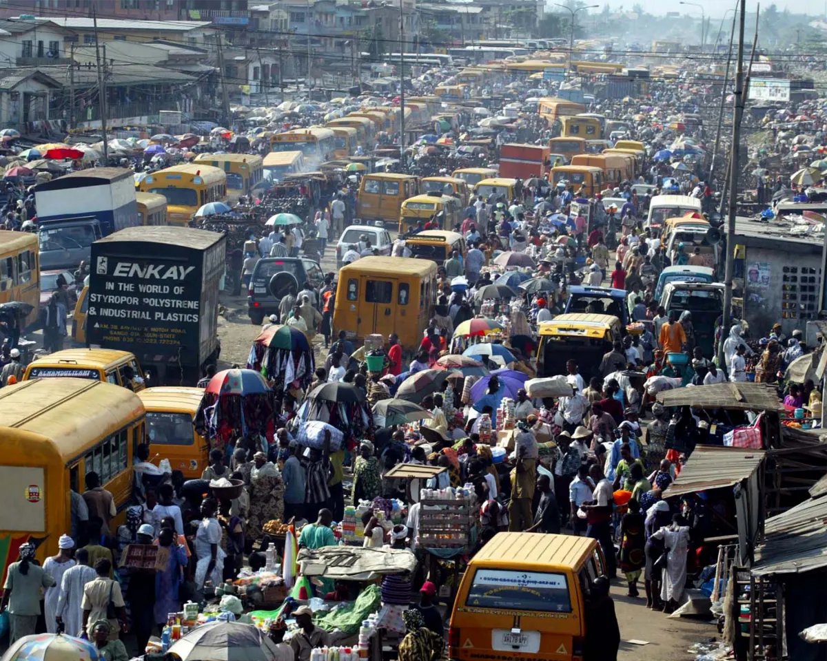 A photo showing thousands of Nigerian merchants and shoppers walking through an outdoor market in Lagos, Nigeria on April 18, 2003.