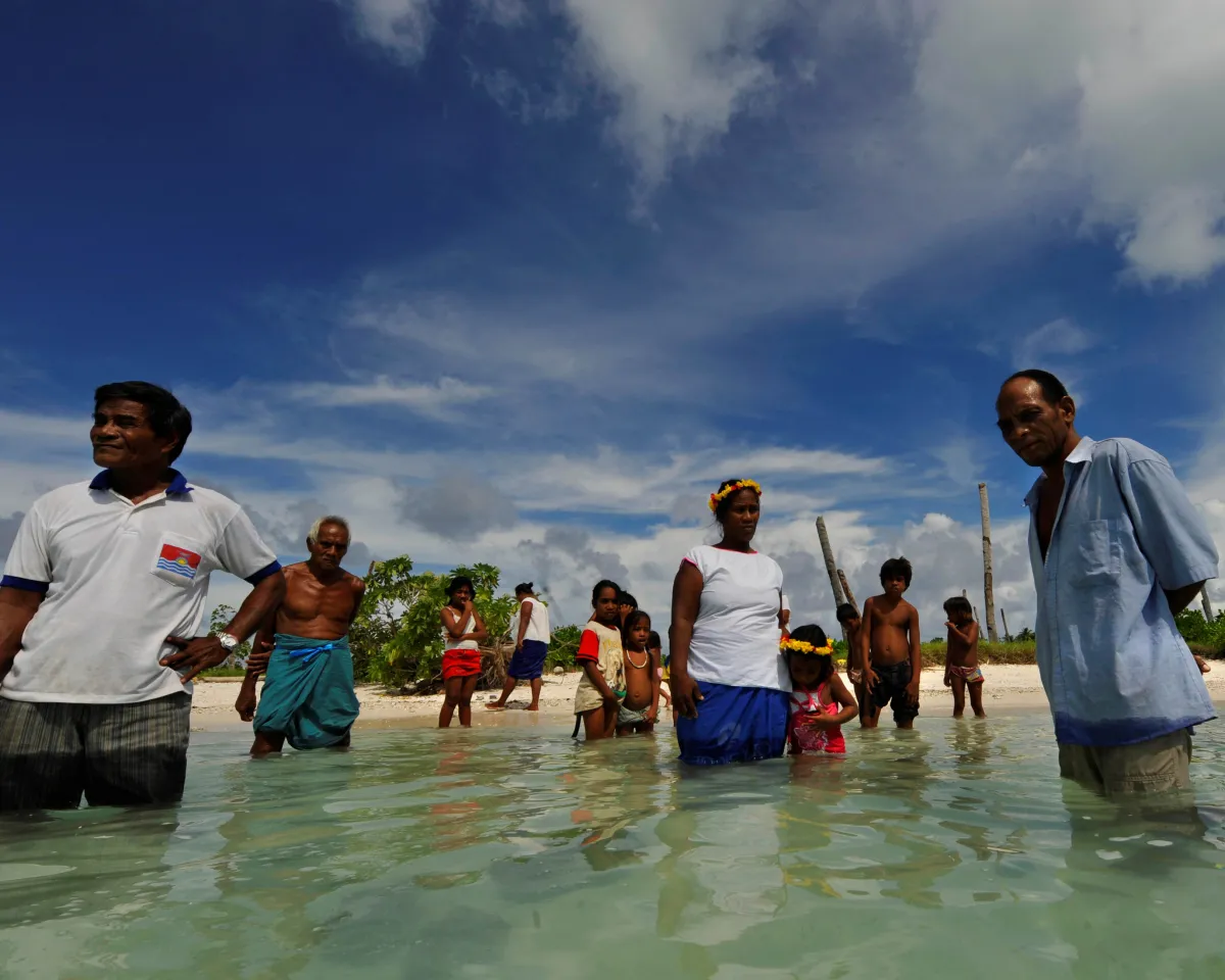 A photo showing residents of Kiribati's island of Abaiang standing where their village used to be, November 13, 2009. Rising seas and erosion have forced them to relocate.