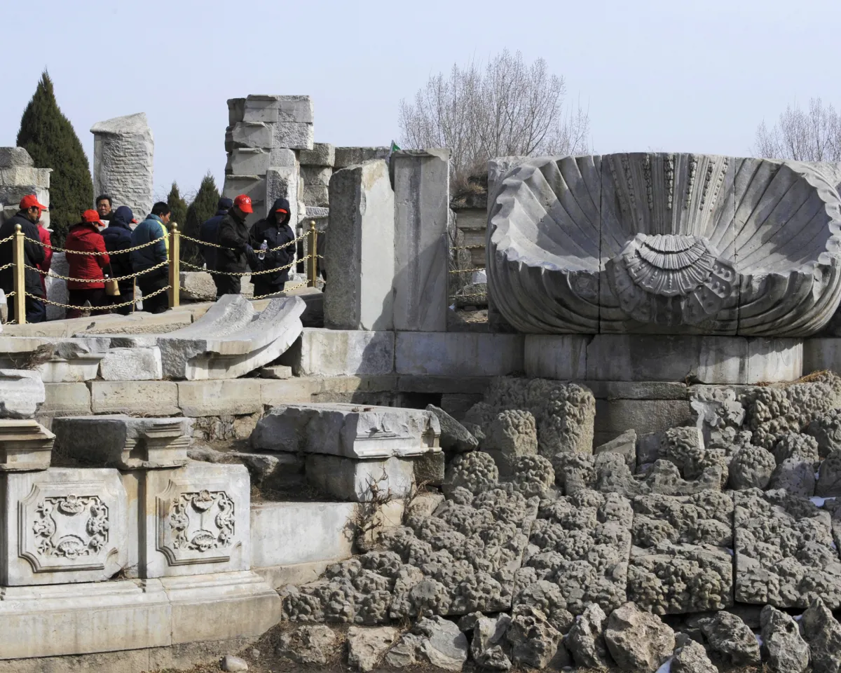 A photo showing tourists admiring the ruins of Haiyan Hall at the Old Summer Palace in Beijing, China on February 24, 2009.