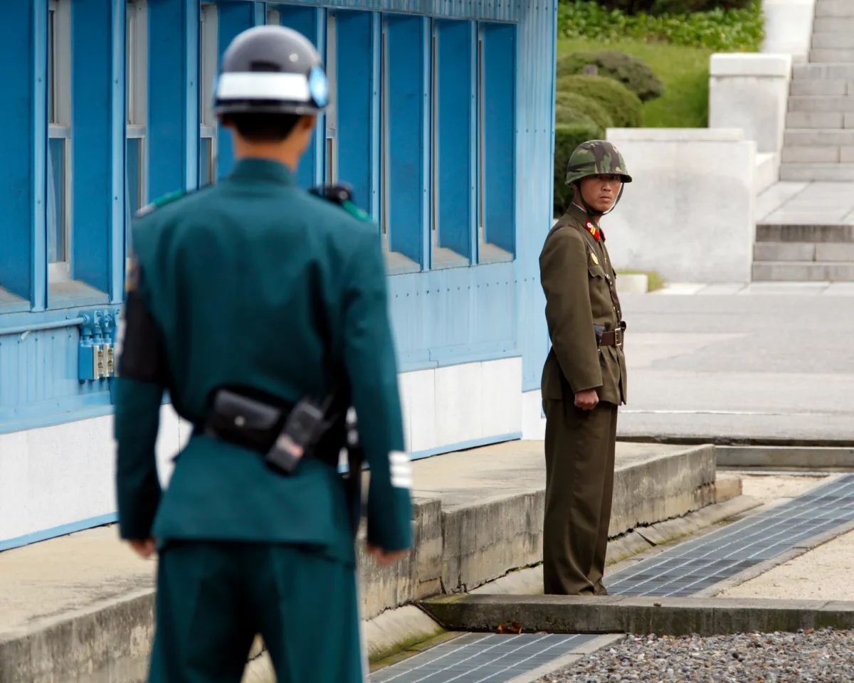 A photo showing a North Korean soldier staring at a South Korean soldier across the concrete border separating the two Koreas in the demilitarized zone on September 29, 2010.
