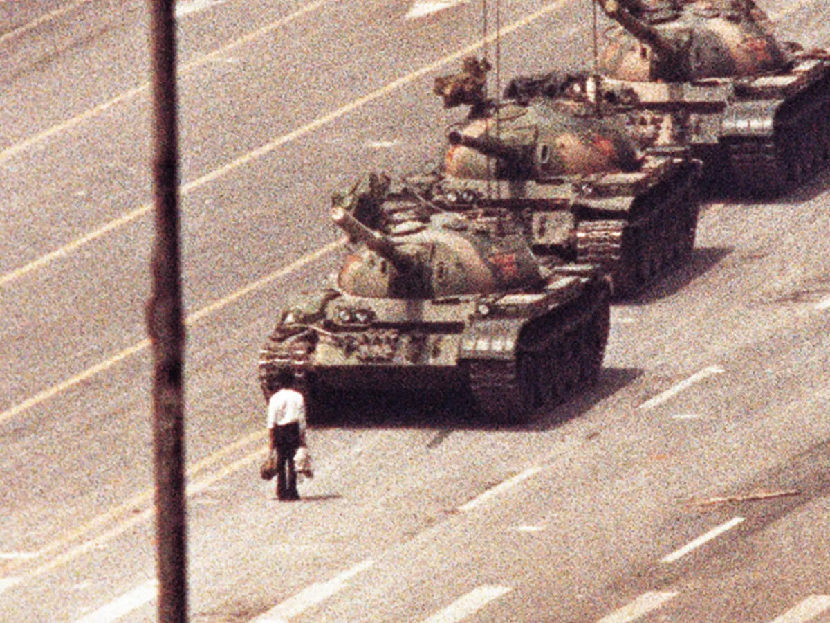 A photo showing a man standing in front of a convoy of tanks in the Avenue of Eternal Peace in Tiananmen Square in Beijing, China on June 5, 1989.