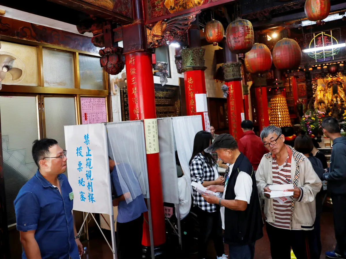 A photo showing people casting their votes at a polling station inside a temple during local elections and referendum on same-sex marriage in Kaohsiung, Taiwan on November 24, 2018.