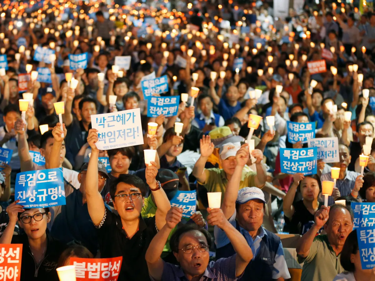 A photo showing thousands of South Koreans taking part in a candle-light demonstration in Seoul demanding an apology from President Park Geun-Hye on August 23, 2013.