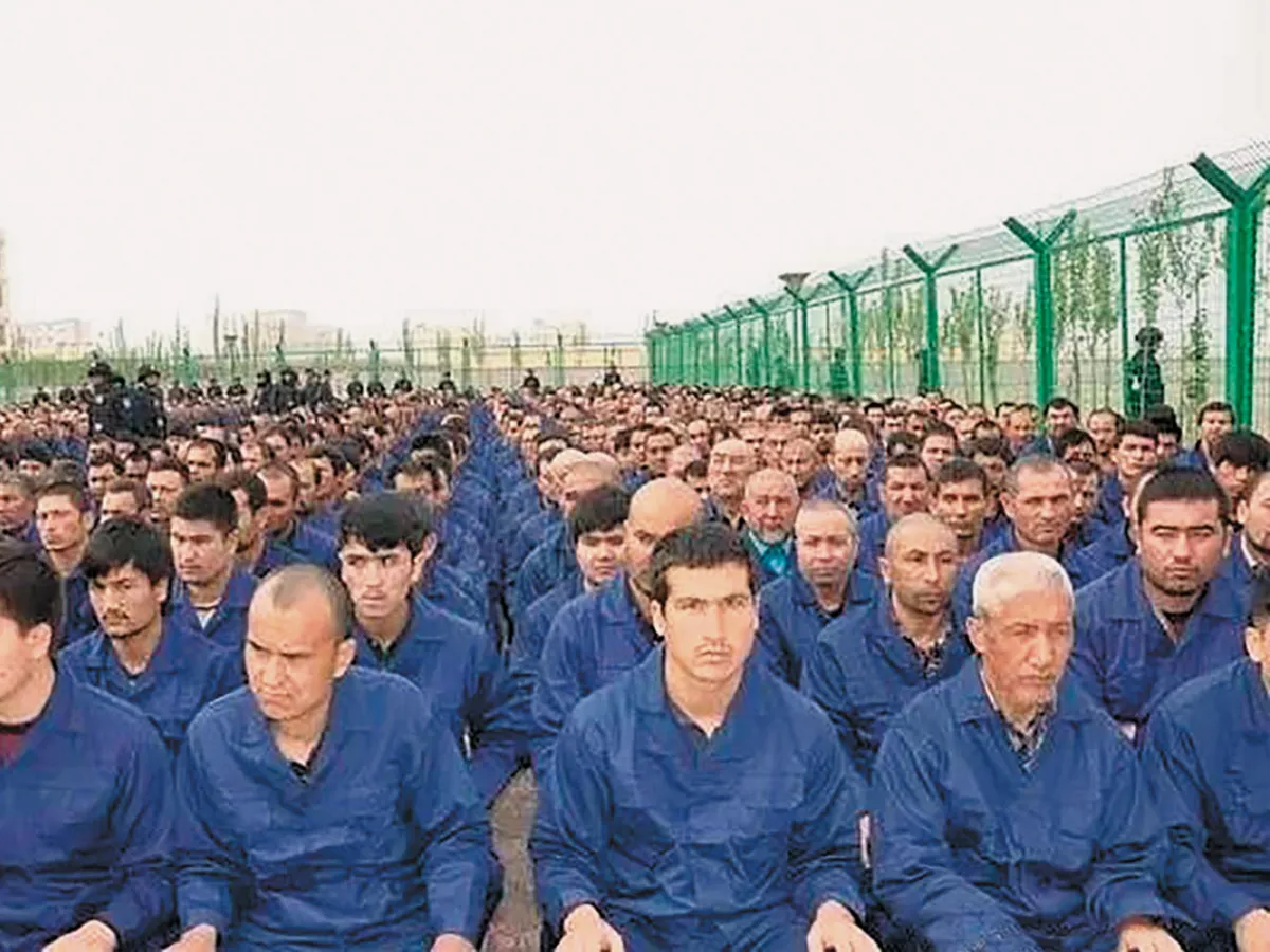 A photo from March 2017 posted to the Xinjiang Judicial Administration’s WeChat account, showing Uighur detainees at a “deradicalization” presentation at a reeducation camp in Hotan Prefecture, Xinjiang.