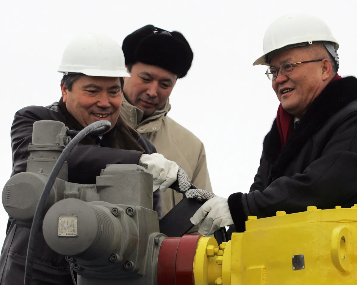 A photo showing Uzakbai Karabalin, president of Kazakhstan's state oil firm, and Zhou Ji Pin, vice president of the China National Petroleum Corporation, ceremoniously opening an oil pipeline in Atasu, Kazakhstan, on December 15, 2005.