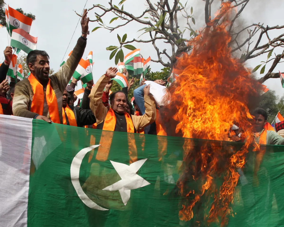 A photo showing supporters of multiple Hindu nationalist groups burning the Pakistan national flag during a protest rally in Jammu on February 11, 2018.