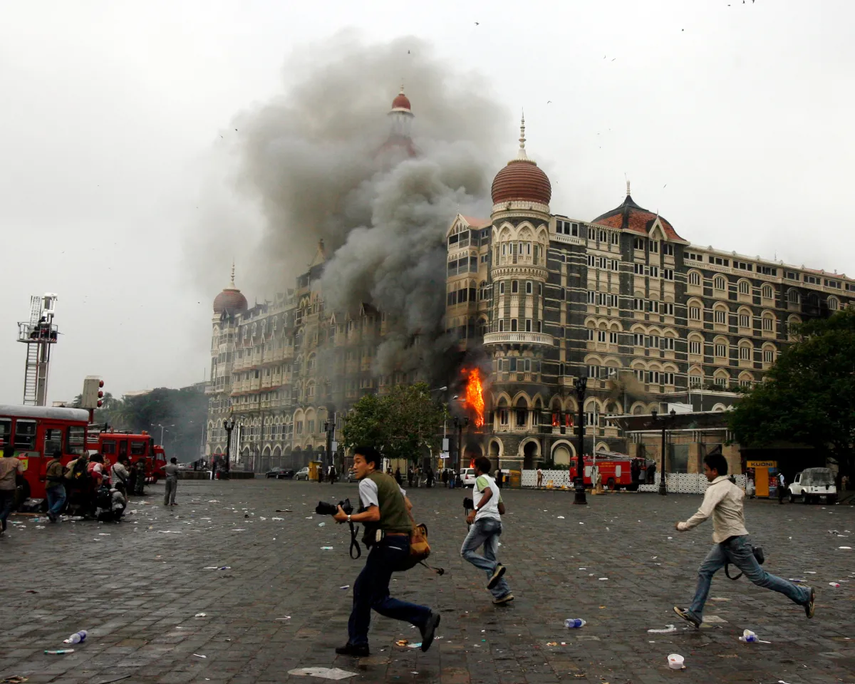 A photo showing photographers running past the Taj Mahal Hotel in Mumbai, India, on November 29, 2008. The hotel was one of the sites targeted during a coordinated terror attack on the city.
