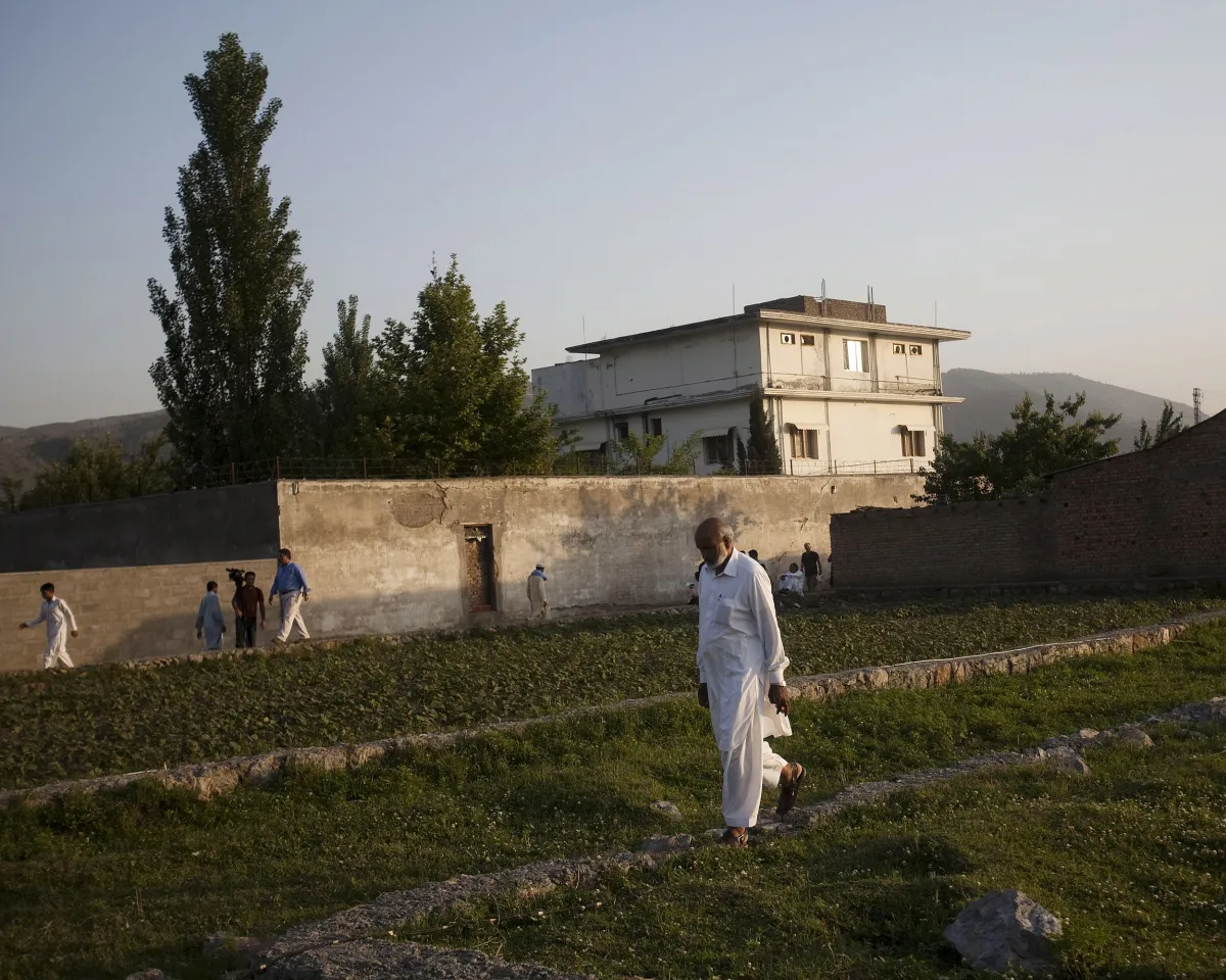 A photo showing a local man walking near Osama Bin Laden's compound on May 3, 2011, one day after the al-Qaeda leader was killed during a raid by U.S. special forces.