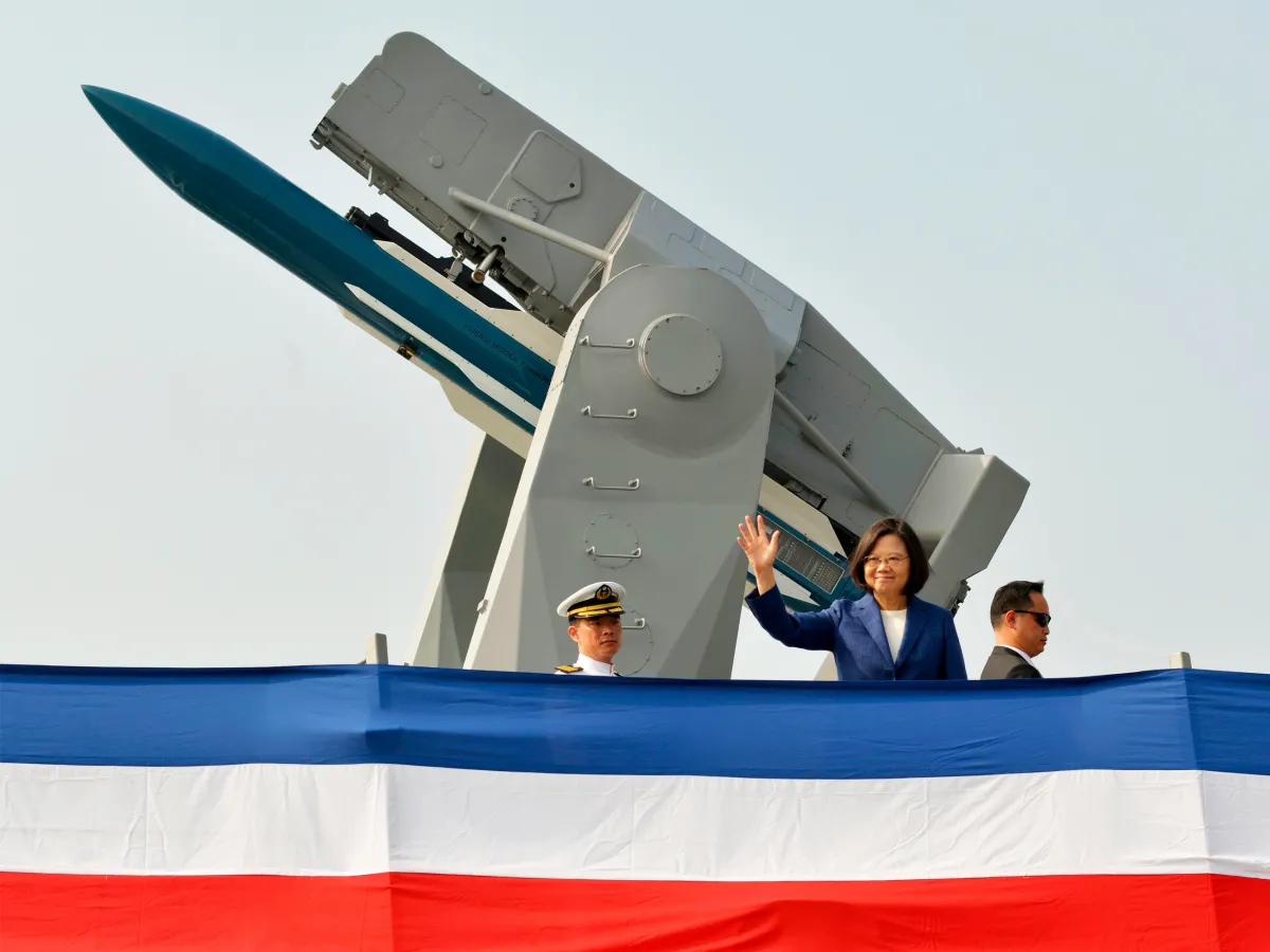 A photo showing Taiwan's President Tsai Ing-wen waving to guests from the deck of the 'Ming Chuan' frigate during a ceremony to commission two Perry-class guided missile frigates Taiwan bought from the US, at Kaohsiung on November 8, 2018.