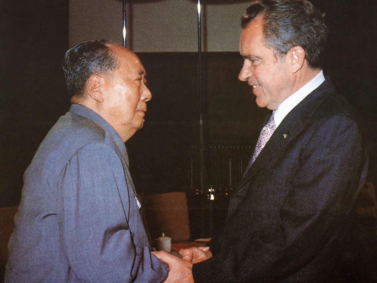 A photo showing Chinese communist leader Chairman Mao Zedong welcoming U.S. President Richard Nixon to his house in Beijing on February 21, 1972.