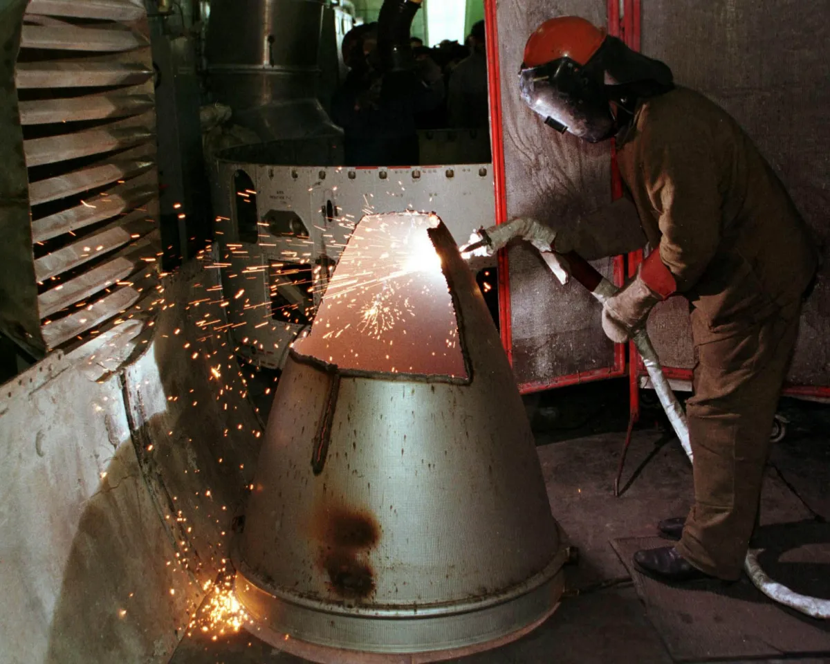 A photo of a worker cutting apart the booster of the SS-19 nuclear weapon at a missile dismantling site in Dnepropetrovsk, Ukraine on February 26, 1999.