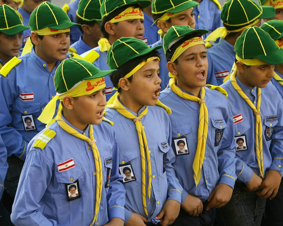 A photo showing Lebanese boys wearing patches with a portrait of Iran's Ayatollah Khomeini marching during a show by the Shiite Muslim Hezbollah Scouts in Beirut, Lebanon, on September 4, 2010.