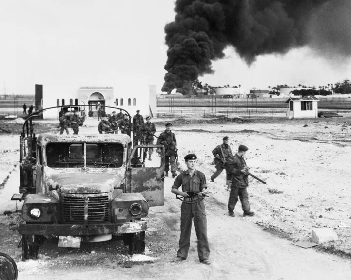 A photo of British troops invading Egypt and oil installations burning at Port Said, north of the Suez Canal, on November 10, 1956.