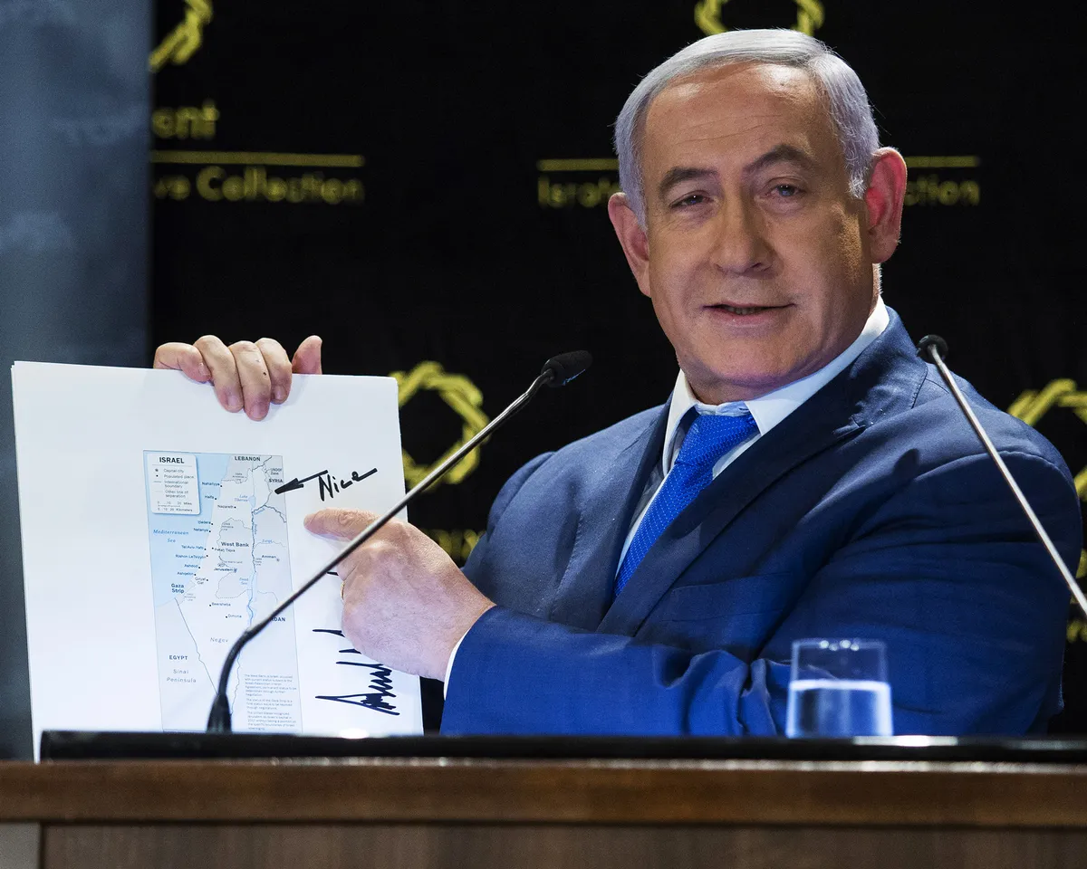 A photo showing Israeli Prime Minister Benjamin Netanyahu presenting a map of Israel that includes the Golan Heights and was signed by US President Donald Trump, on May 30, 2019 in Jerusalem, Israel.