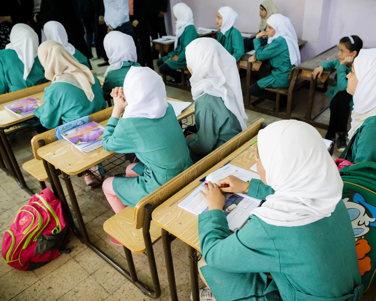 A photo showing girls sitting on school benches during a lesson in the Ajnadayn girls school on October 05, 2016 in Irbid, Jordan.
