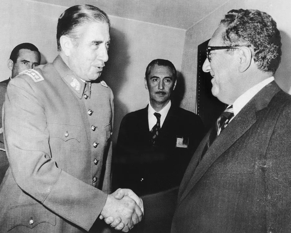 A photo of Chilean President Augusto Pinochet greeting U.S. Secretary of State Harry Kissinger in Pinochet's office in Santiago, Chile, on June 8, 1976.
