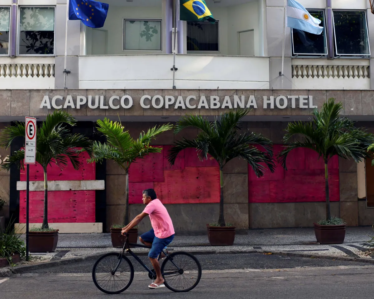 A photo showing a man riding his bicycle past the Acapulco Copacabana Hotel, which is temporarily closed amid the coronavirus disease (COVID-19) outbreak, in Rio de Janeiro, Brazil, on April 3, 2020.