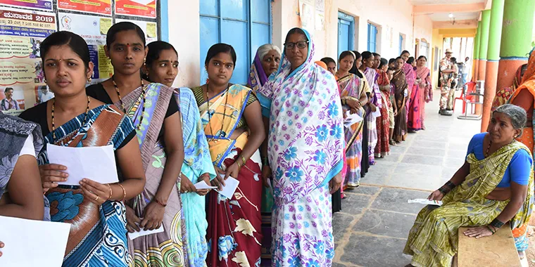 Indian women stand in queue at a polling station to cast their vote during the third phase of India's general election in Dharwad, some 450 kilometers northwest of Bangalore, on April 23, 2019.
