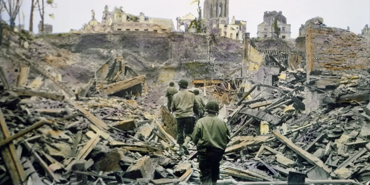 An American infantry patrol walks through the ruins of the French town of Saint-Lo, after it was captured from Germans in the Battle of Normandy in July 1944.