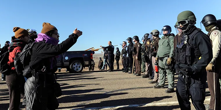 Police block the highway from protesters next to the pipeline route during a protest against the Dakota Access pipeline near the Standing Rock Indian Reservation in St. Anthony, North Dakota on November 11, 2016.