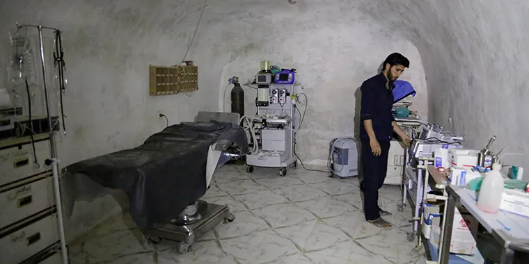 A medic stands at the operation room of a field hospital which was set inside a cave in the town of al-Latamna, in the northern countryside of Hama, Syria, on March 9, 2015.