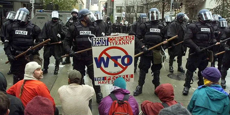 Protesters block a police line from moving forward in a downtown Seattle intersection on November 30, 1999, on the first day of meetings for the World Trade Organization conference.