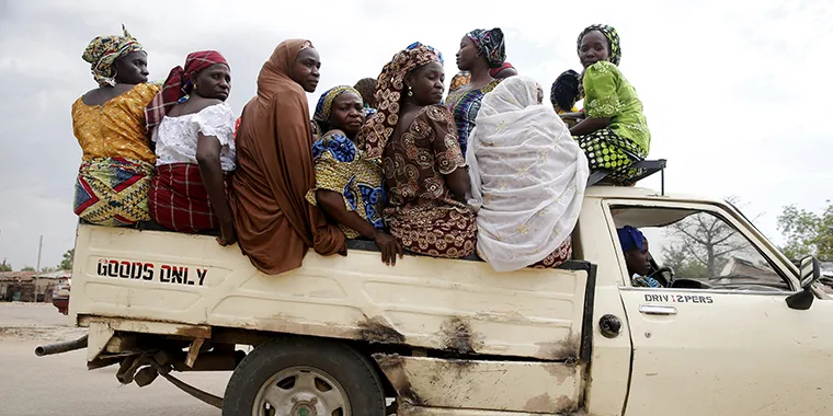 Women travel in the back of a truck in the town of Mararaba in Adamawa state, Nigeria, on May 10, 2015.