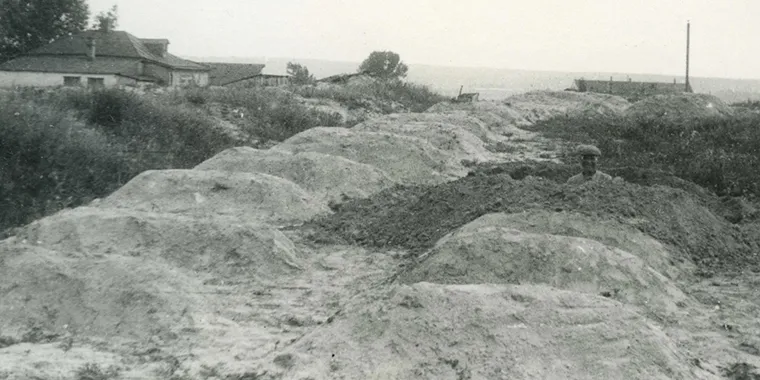 A gravedigger pauses at a mass grave site for unidentified victims of famine on the edge of Kharkiv, Ukraine, in 1933.