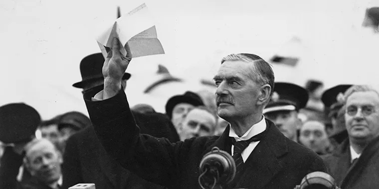 British Prime Minister Neville Chamberlain at Heston Airport in London on his return from Munich after meeting with Hitler, making his "Peace for Our Time" address, on September 30, 1938.