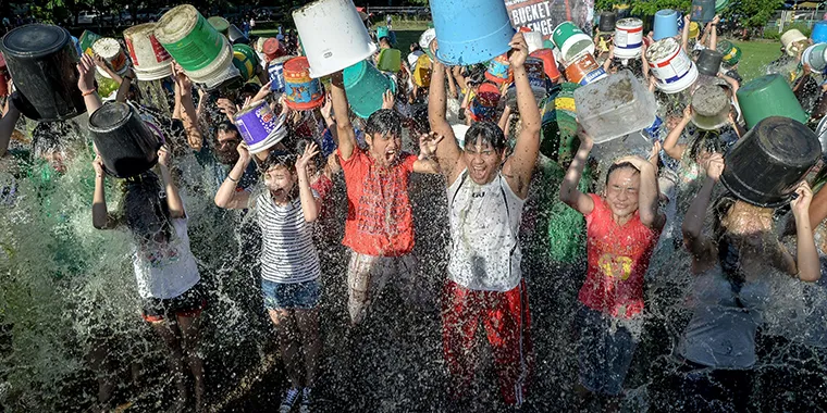 Filipinos dump buckets of ice water on themselves as they take part in the ALS Ice Bucket Challenge in suburban Quezon, north of Manila in the Philippines, on September 7, 2014.