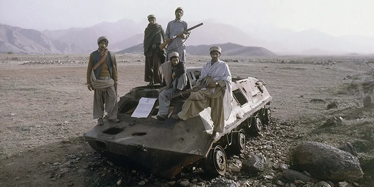 Afghan rebels on top of knocked out Russian armored vehicle in Afghanistan in February 1980.