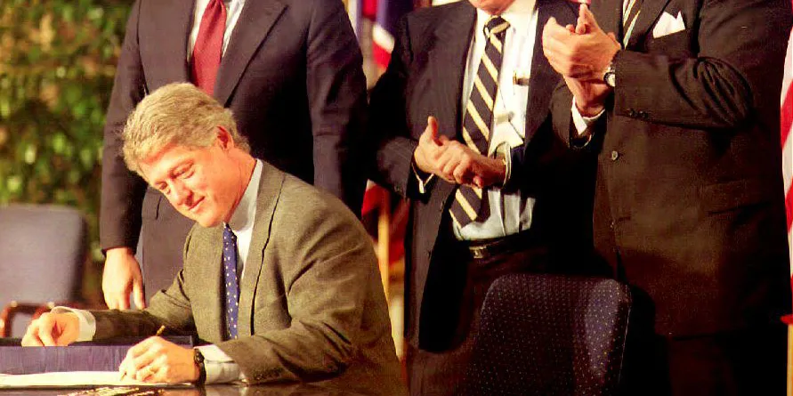 U.S. President Bill Clinton signs the North American Free Trade Agreement (NAFTA) on December 8, 1993.