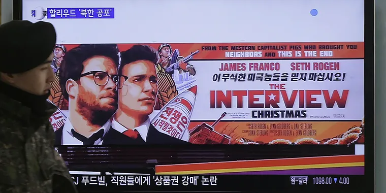 A South Korean army soldier walks near a TV screen showing an advertisement of Sony Pictures' The Interview in Seoul, South Korea, on December 22, 2014.