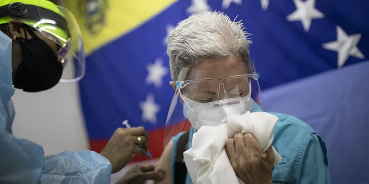 Dr. Zaira Medina, director of the Ana Francisca Pérez de Leon II public hospital, vaccinates a high-risk person at the hospital on February 23, 2021 in Caracas, Venezuela.