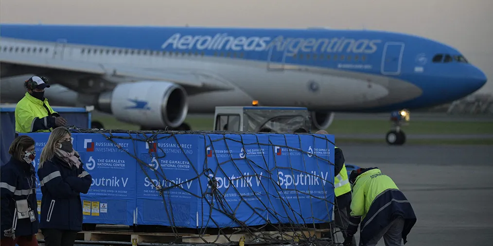 Shipping containers with 300 liters of the first batch of active ingredient to produce Sputnik V vaccines in an Argentine lab are seen on board the Aerolineas Argentinas airplane at the tarmac of Ezeiza International airport in Buenos Aires, Argentina, on