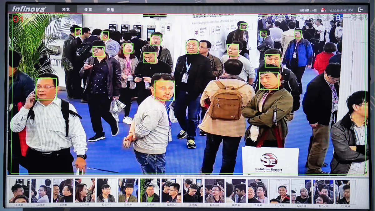 A screen shows visitors being filmed by AI (artificial intelligence) security cameras with facial recognition technology at the 14th China International Exhibition on Public Safety and Security at the China International Exhibition Center in Beijing.