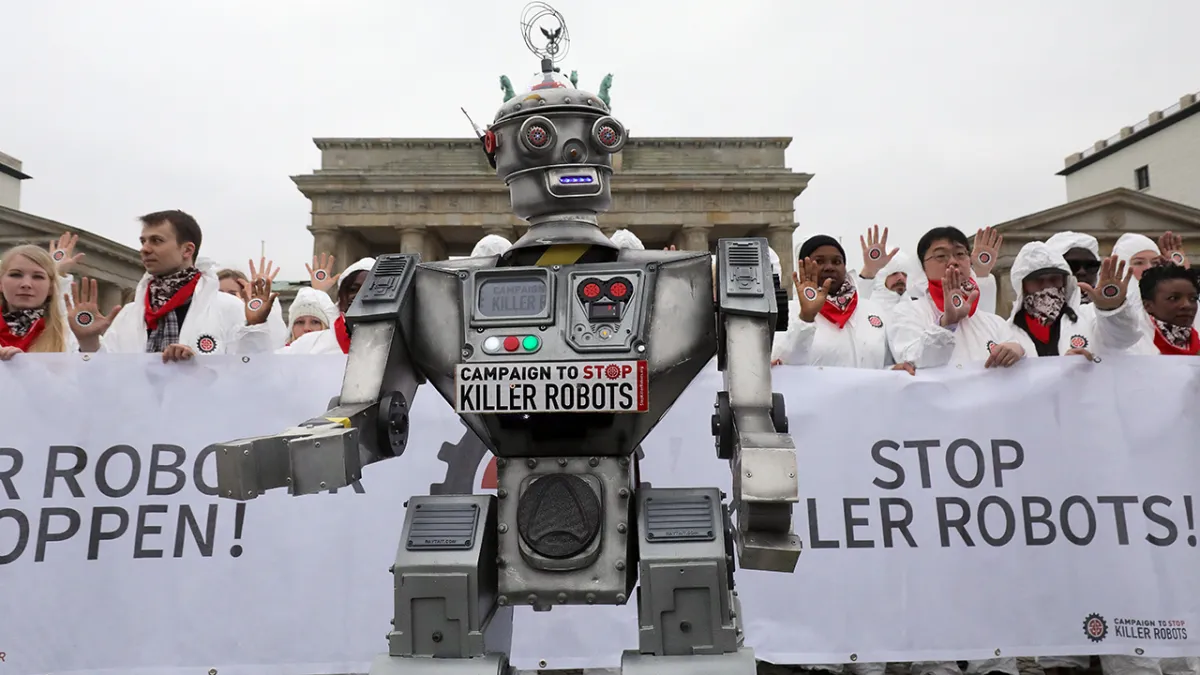 People take part in a demonstration as part of the "Stop Killer Robots" campaign organized by German NGO "Facing Finance" to ban what they call killer robots on March 21, 2019 in front of the Brandenburg Gate in Berlin. 