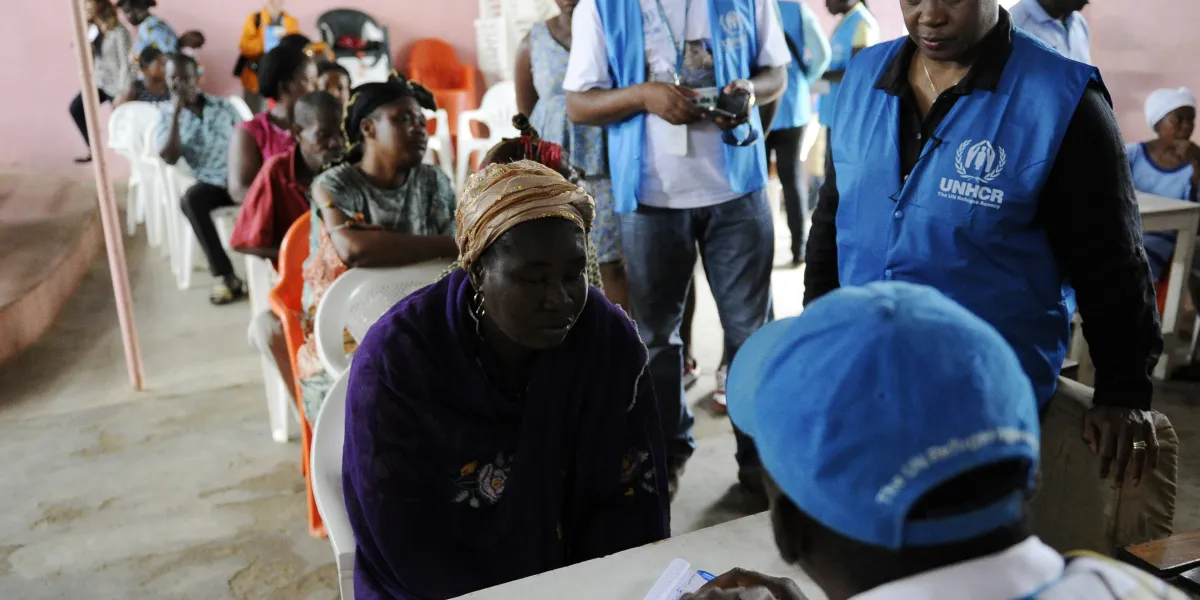 US opera singer and goodwill ambassador for the United Nations High Commissioner for Refugees (UNHCR) Barbara Hendricks (R) looks on as stateless people are registered on June 26, 2014.