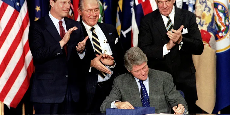 President Bill Clinton signs NAFTA into law, on December 8, 1993. The trade deal includes the diverse economies of the United States, Canada, and Mexico.