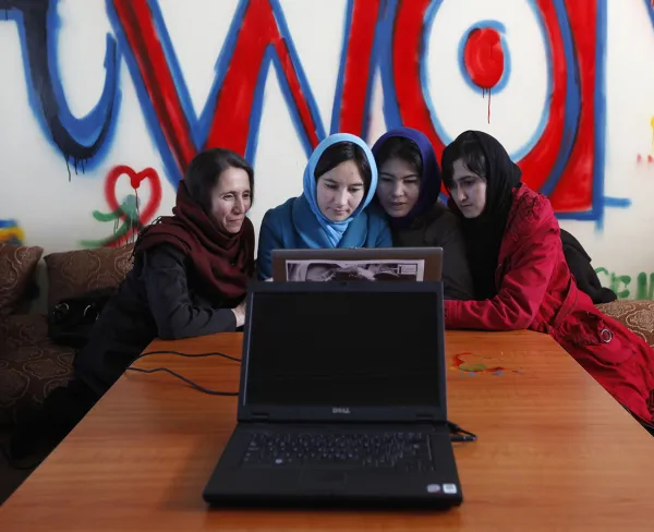 Girls work in Kabul at Afghanistan's first female-only internet cafe on March 8, 2012.