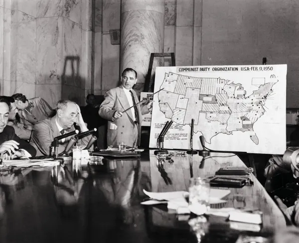 Joseph McCarthy points at a map of the United States as he testifies on Communist Party organization on June 9, 1954.